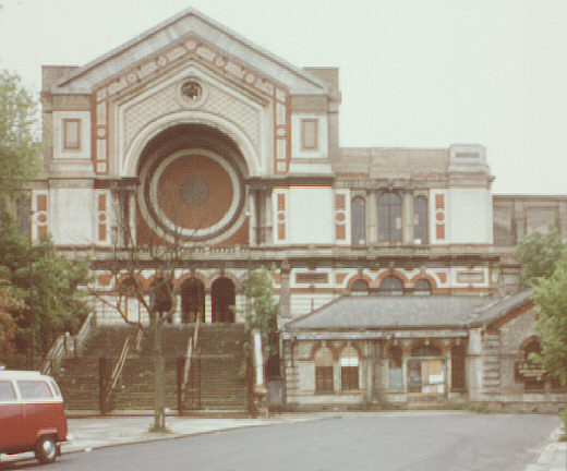 London, UK. Summer 1980. North-west entrance to Alexandra Palace, with old railway station.