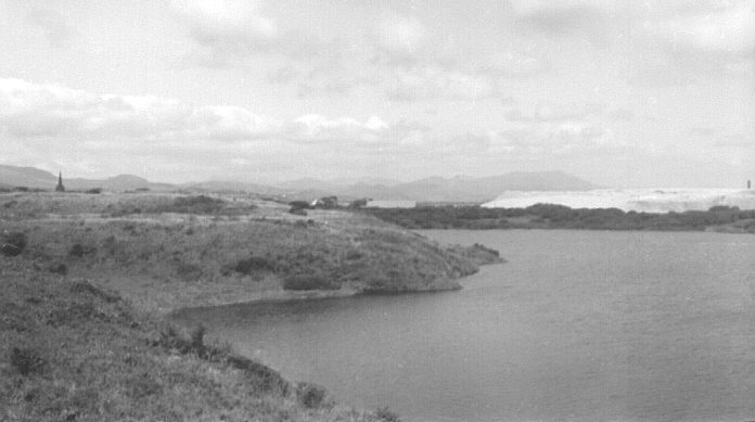 Hodbarrow iron ore mine, Cumbria, UK. Summer 1968. Looking along edge of lagoon to spoil heaps