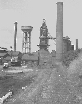Millom ironworks, Cumbria, UK. Summer 1968. Blast furnace, water-tower, etc. from west